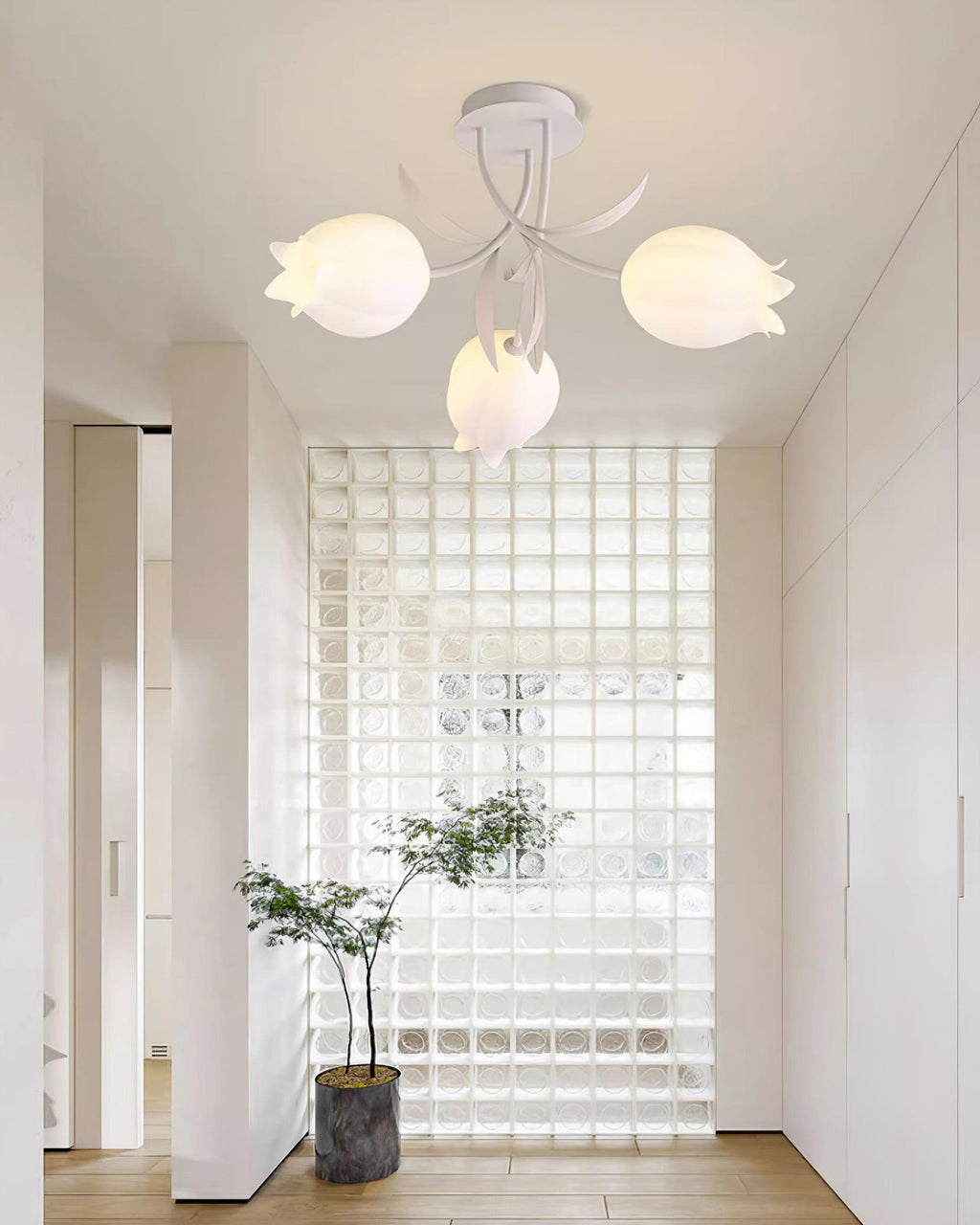 In a hallway lined with glass-block glazing, this Clérachic ceiling light in green hangs above a small potted plant.