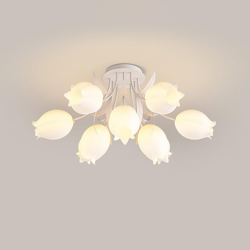 Against a warm beige background, this Clérachic ceiling light in green displays a wide arrangement of lily-shaped shades.