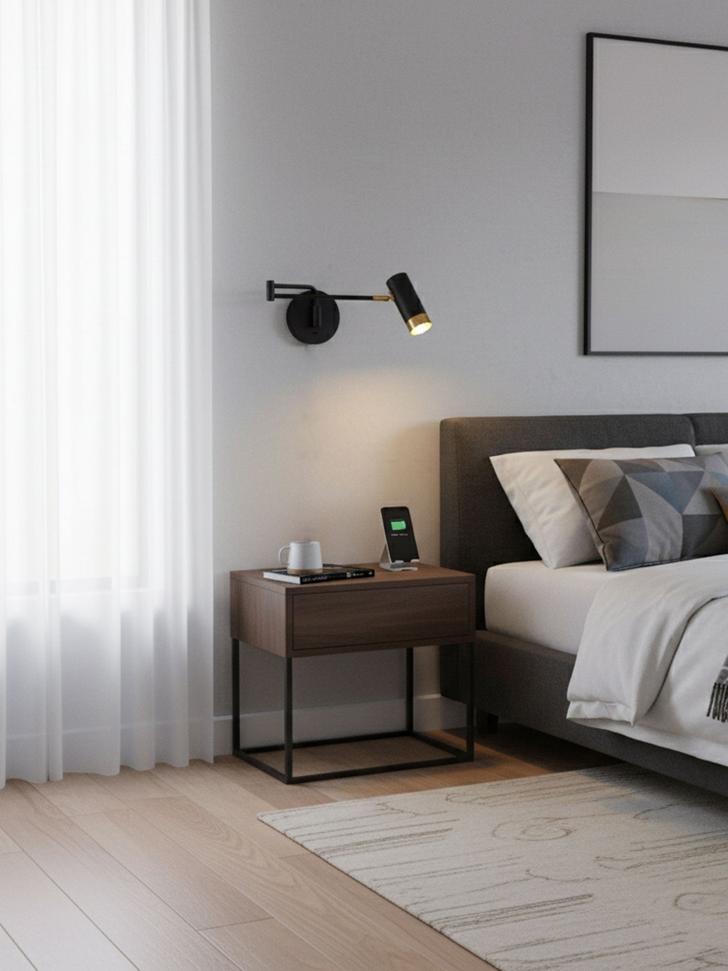 Swing arm wall lamp shown lit against a pale wall