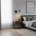 Black and gold swing arm wall lamp in a reading corner
