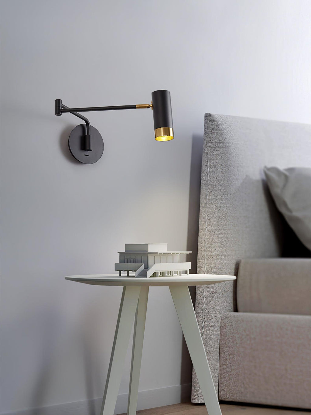 Swing arm wall lamp with long shade and visible arm joint