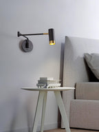 Swing arm wall lamp with long shade and visible arm joint