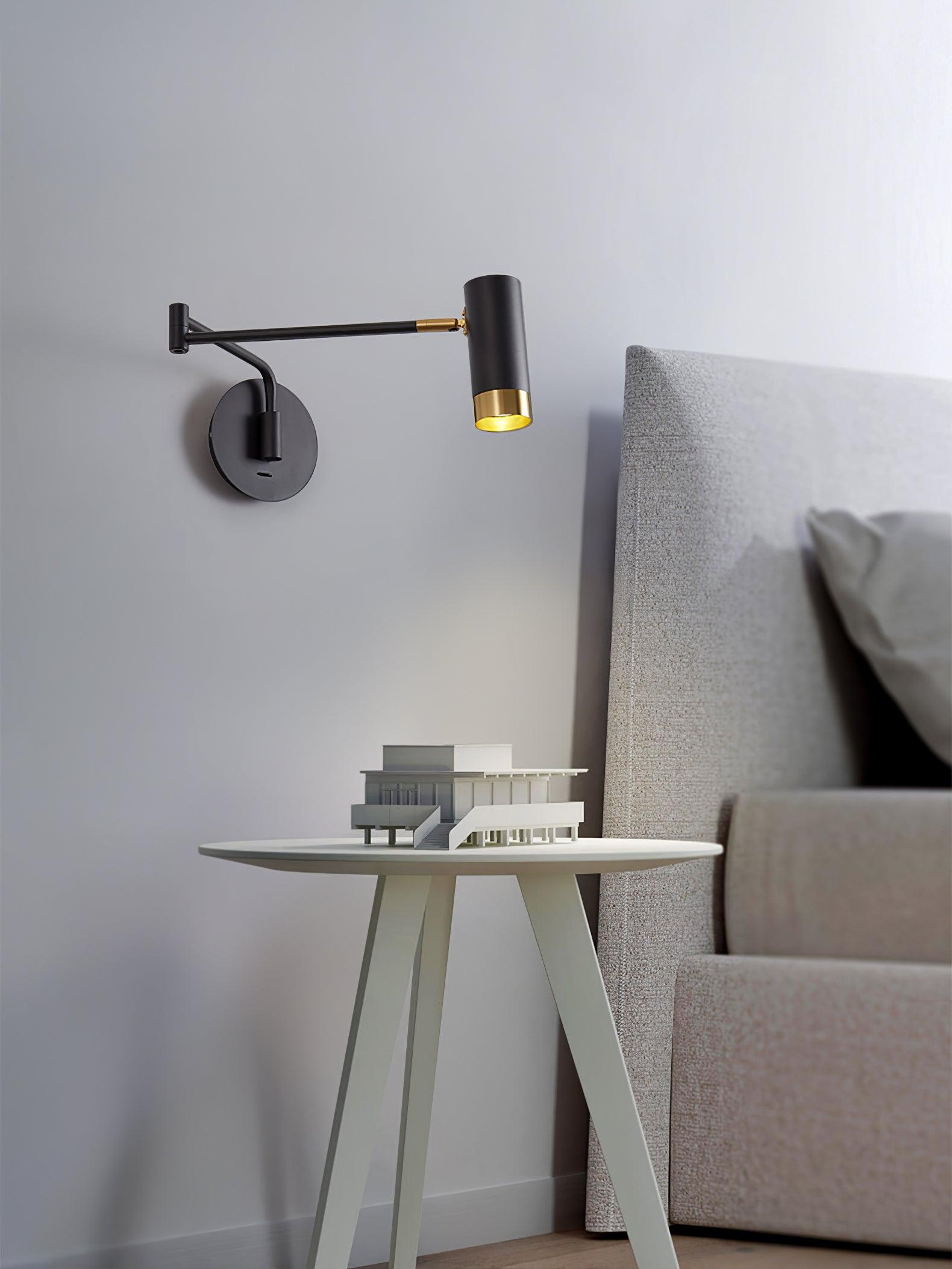 Swing arm wall lamp with long shade and visible arm joint