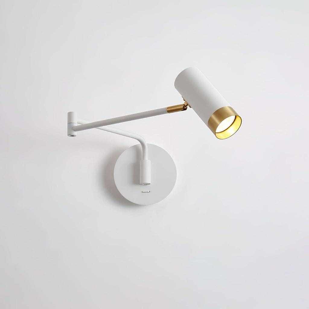 Swing arm wall lamp with elongated shade mounted on a wall