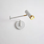 Swing arm wall lamp with elongated shade mounted on a wall
