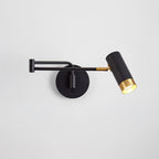 Swing arm wall lamp in white and gold beside a bed
