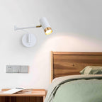 Swing arm wall lamp mounted along a hallway wall