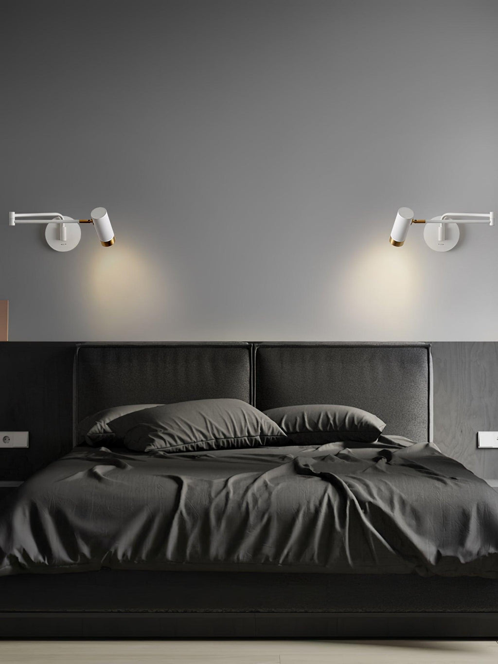 Swing arm wall lamp lit warmly above a bedside table