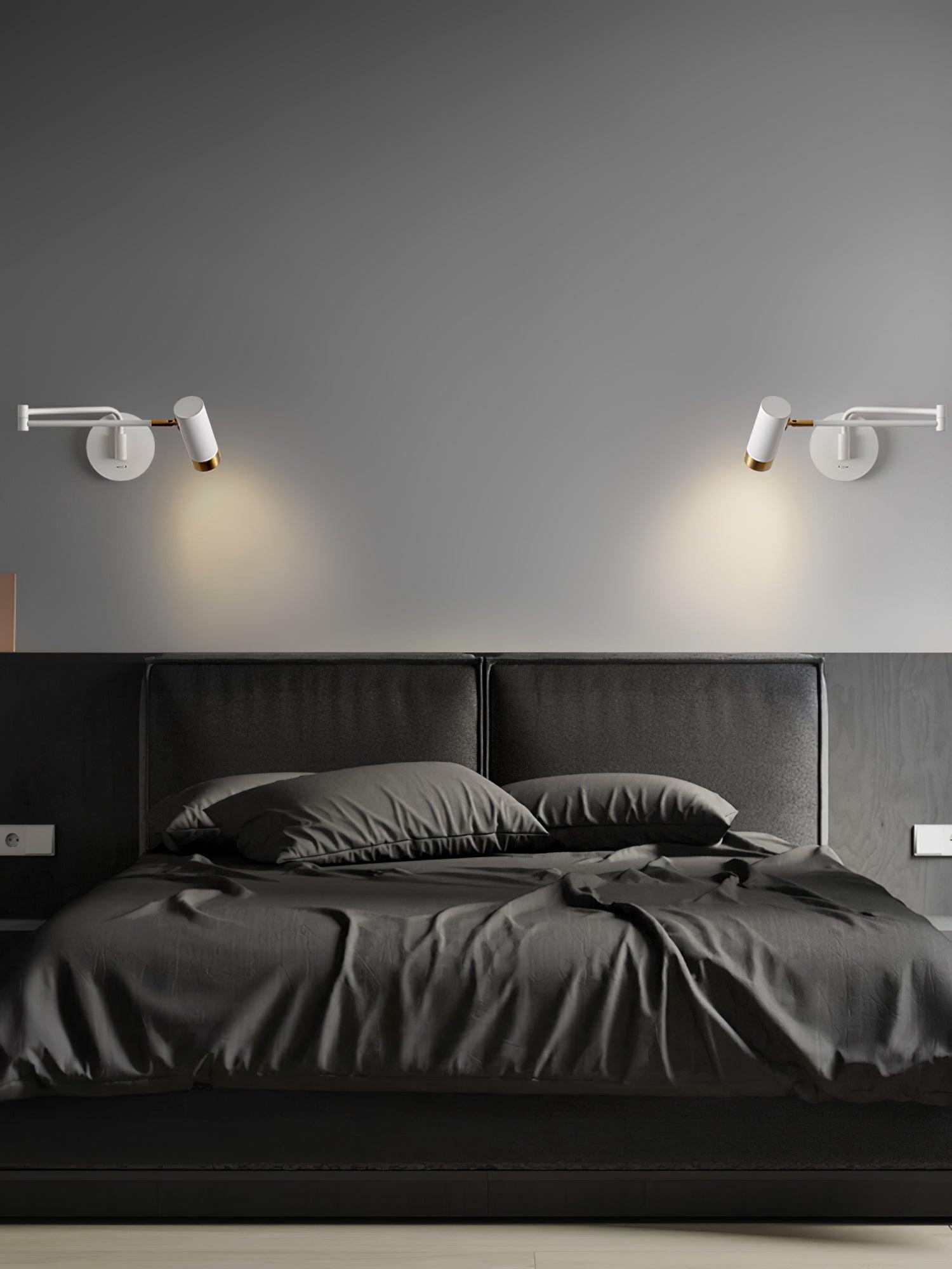 Swing arm wall lamp lit warmly above a bedside table