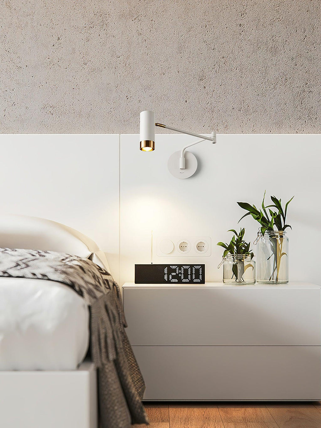 Black and gold swing arm wall lamp on a dark wall