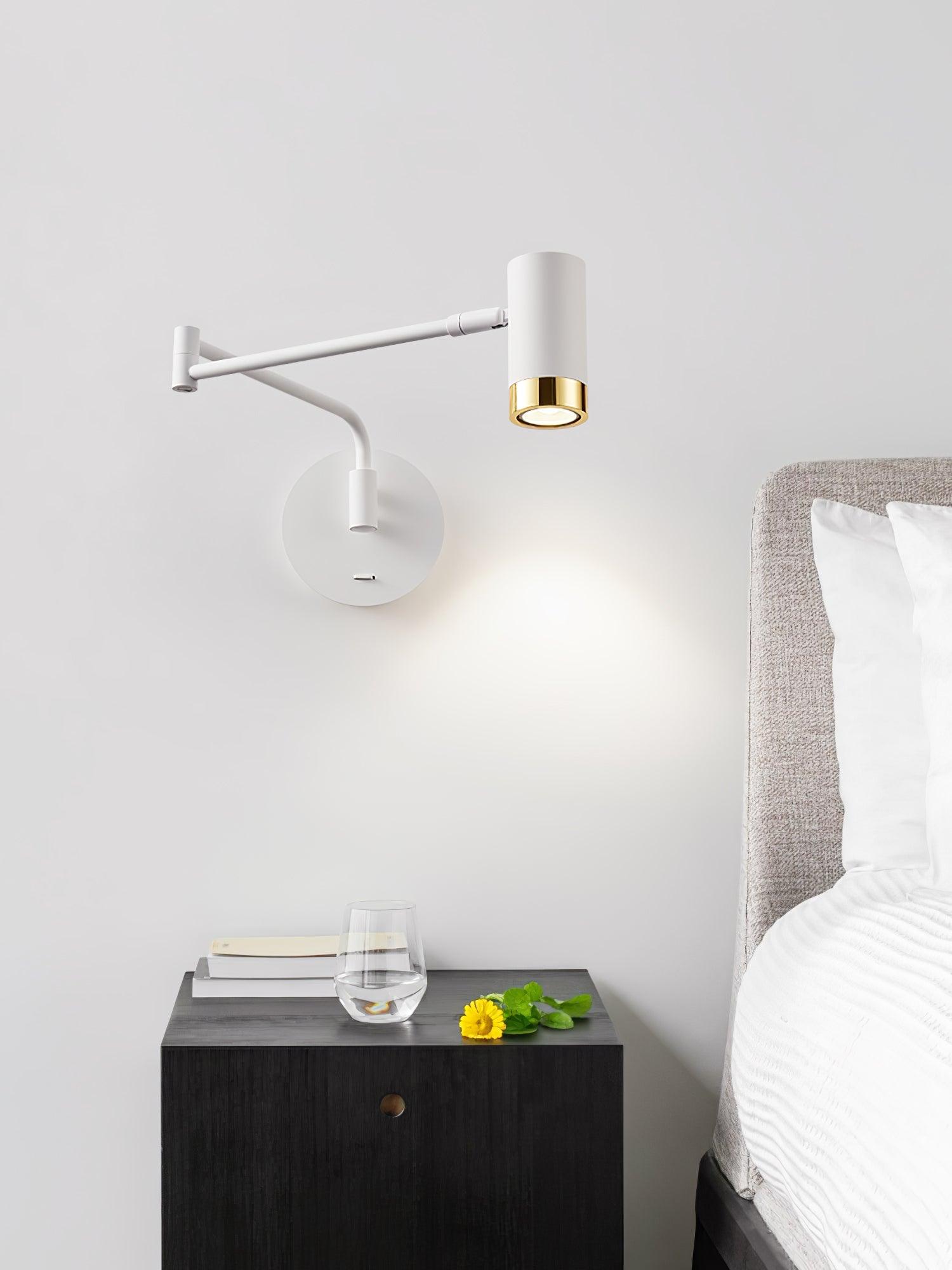 Swing arm wall lamp directing light onto an open book