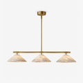 On a plain backdrop, this Clérachic chandelier shows its three alabaster cone shades on a brass bar.
