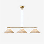 On a plain backdrop, this Clérachic chandelier shows its three alabaster cone shades on a brass bar.