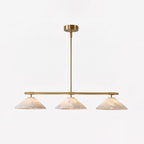 This lit Clérachic chandelier shows its brass stem and alabaster cone shades against a plain white backdrop.