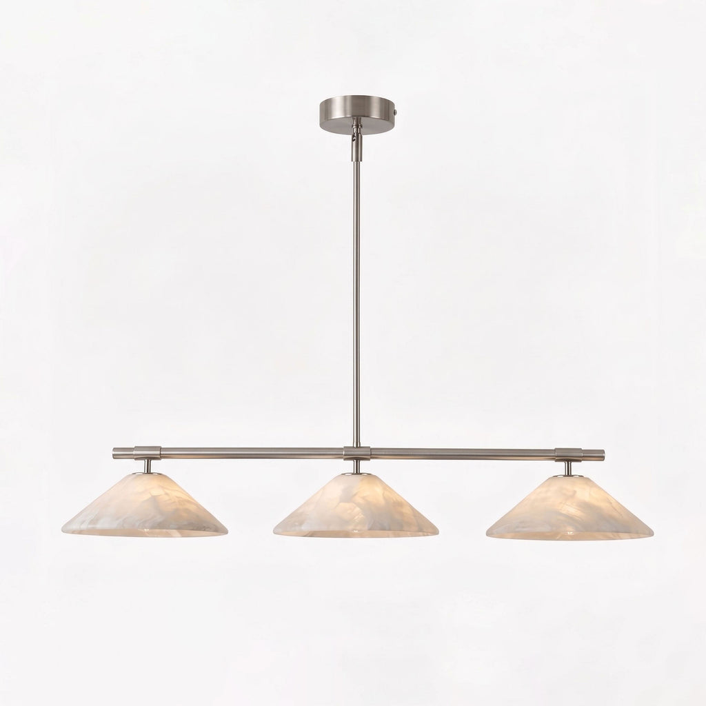 Against a plain white backdrop, this Clérachic chandelier in brushed nickel glows softly.