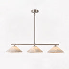 Against a plain white backdrop, this Clérachic chandelier in brushed nickel glows softly.