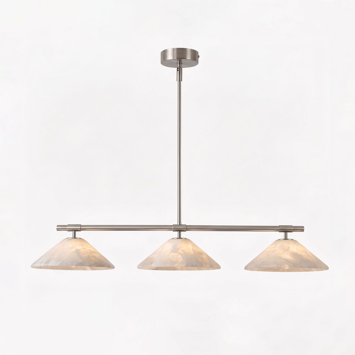 Against a plain white backdrop, this Clérachic chandelier in brushed nickel glows softly.