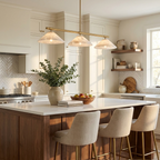 Fresh eucalyptus sits on a herringbone-tiled kitchen island beneath this brass Clérachic chandelier.