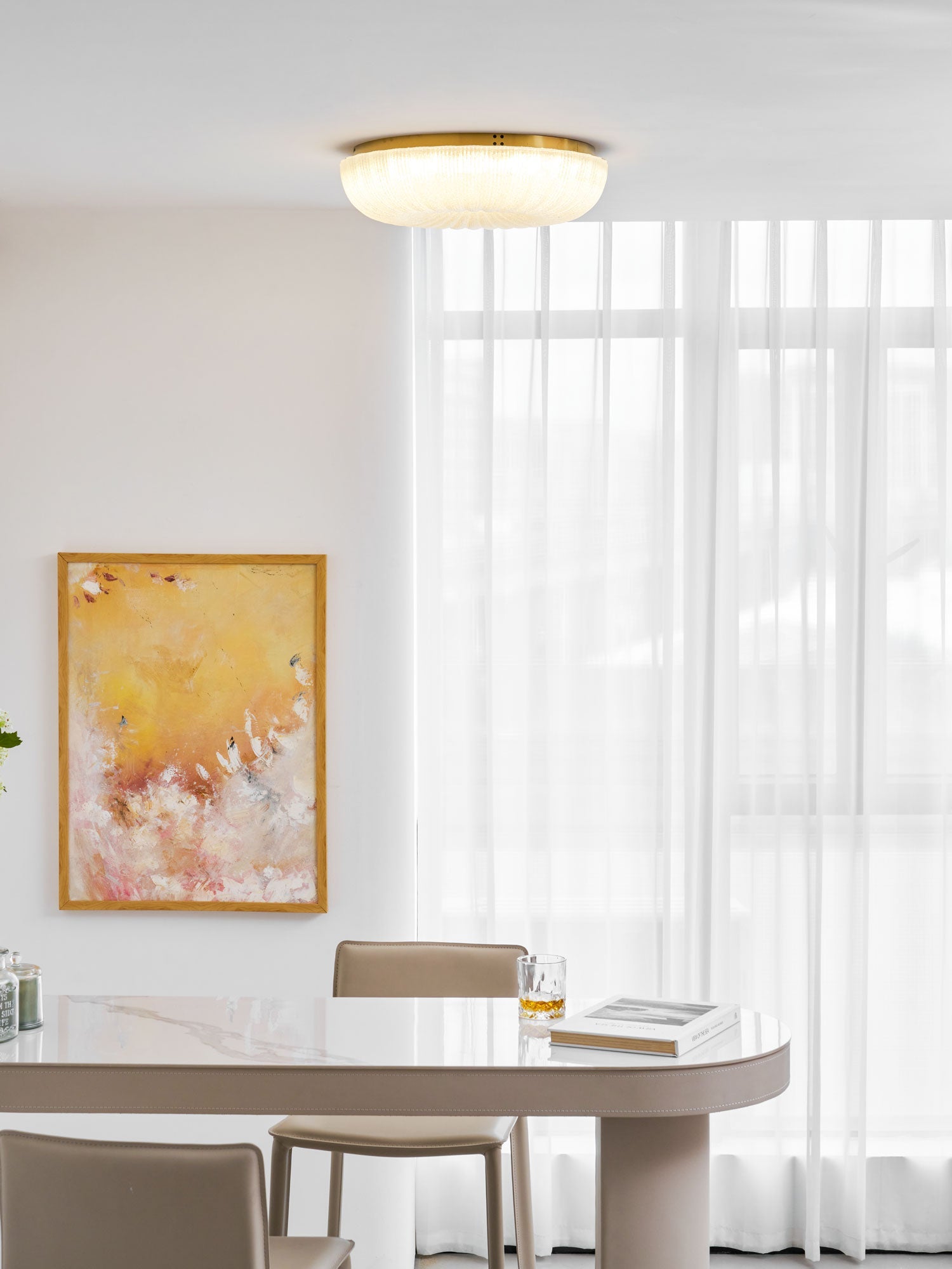 Round frosted glass ceiling light mounted in a bright space