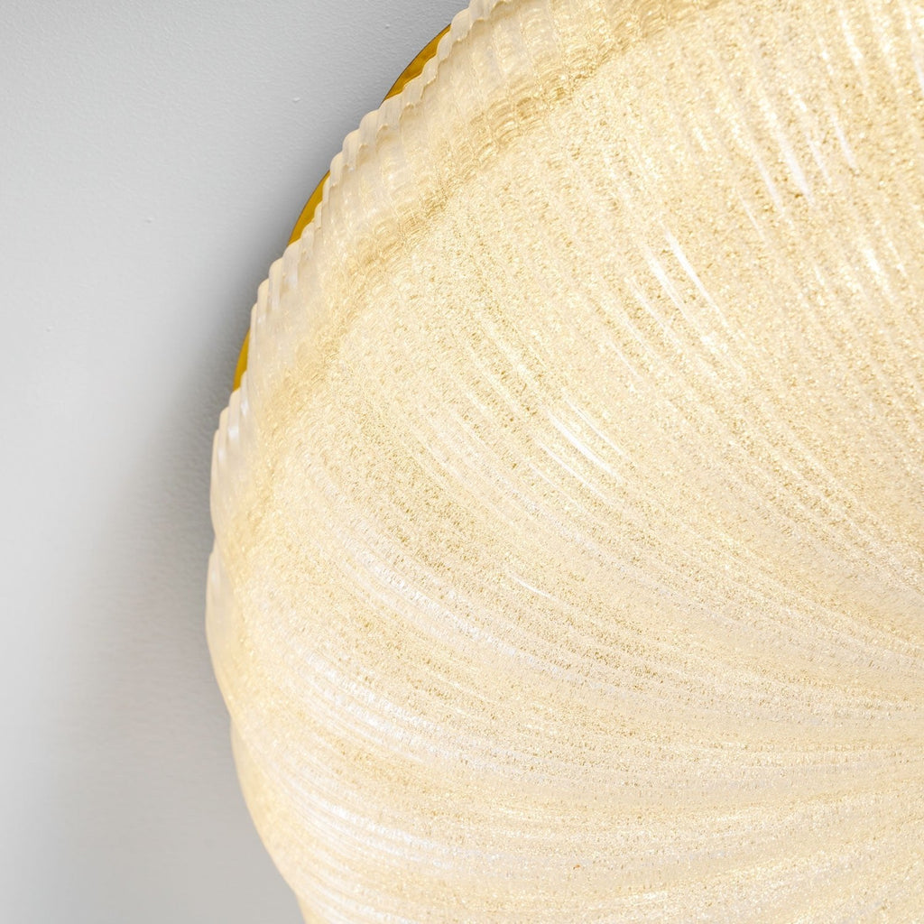 Gold and frosted glass ceiling light styled in a room