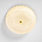 Frosted glass ceiling light detail with the gold rim visible