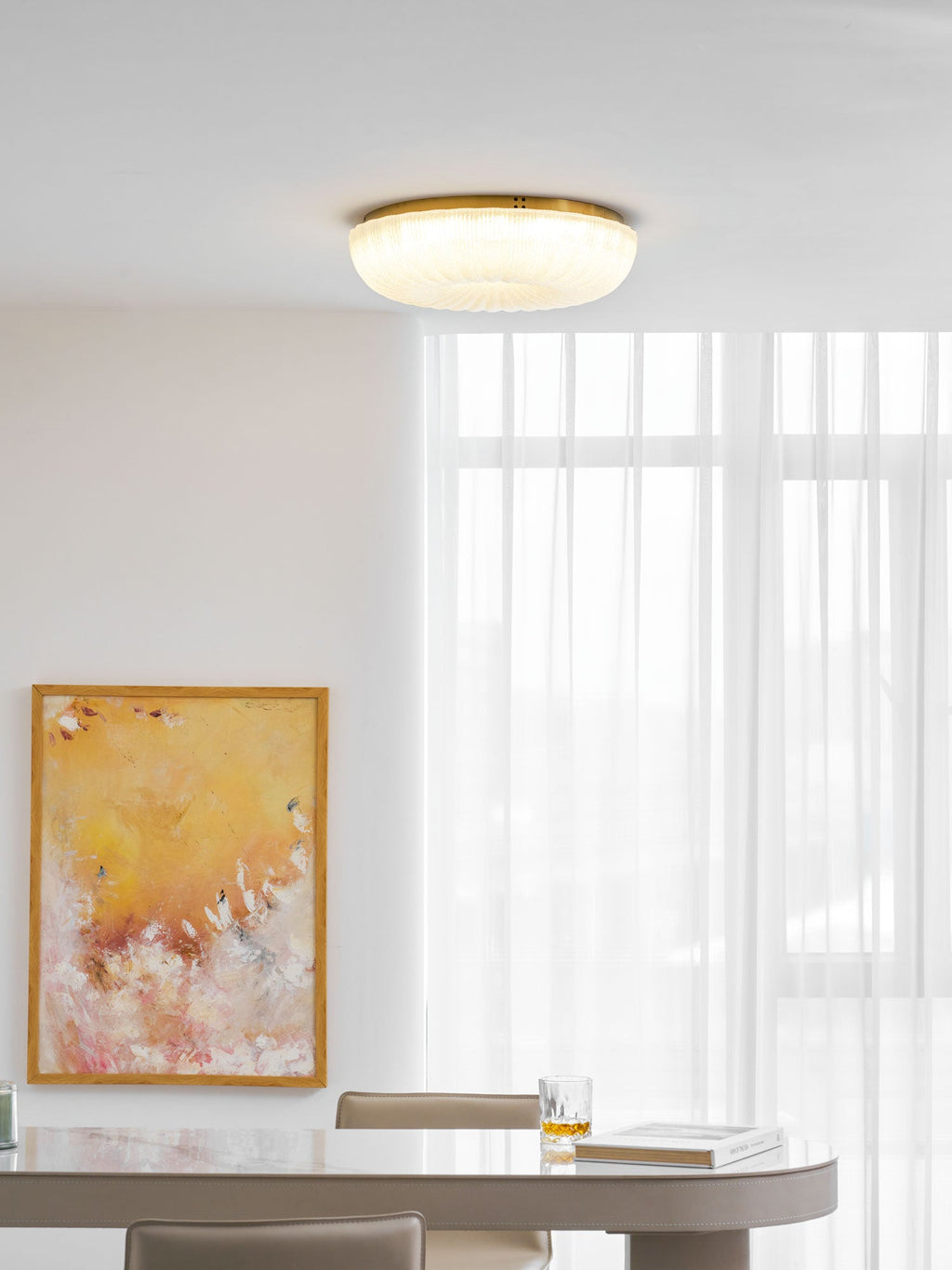 Gold-trimmed frosted glass ceiling light in a warm interior