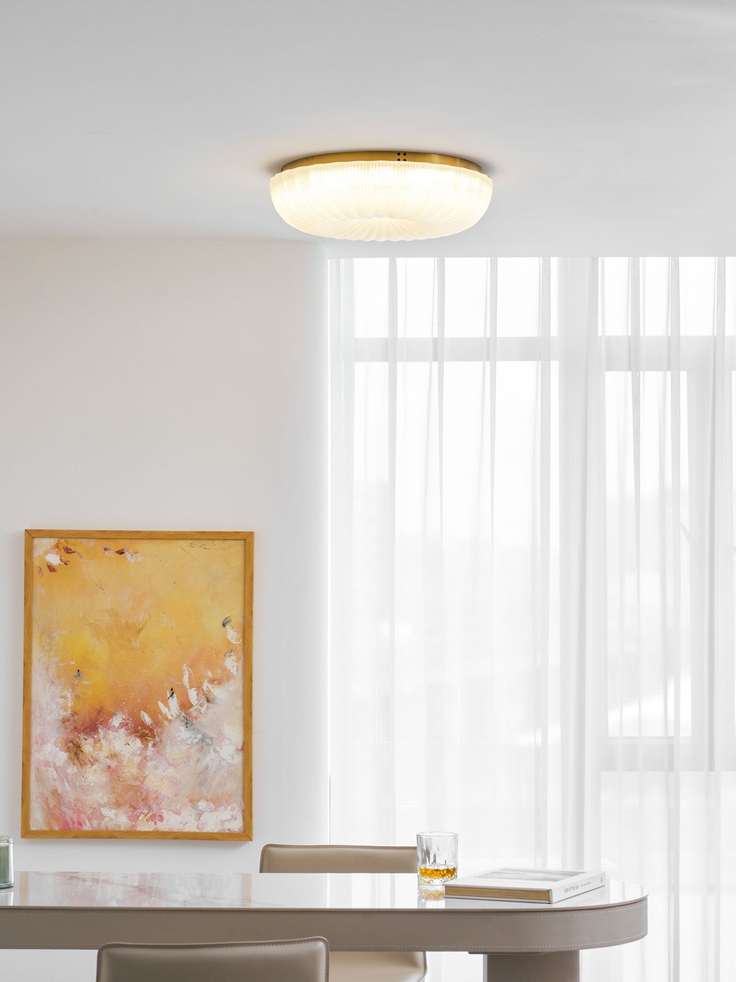 Gold-trimmed frosted glass ceiling light in a warm interior