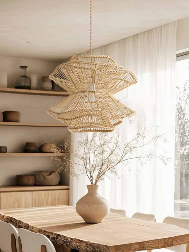 Between open shelving and a sheer-curtained window, this Clérachic pendant hangs above a live-edge wood table.