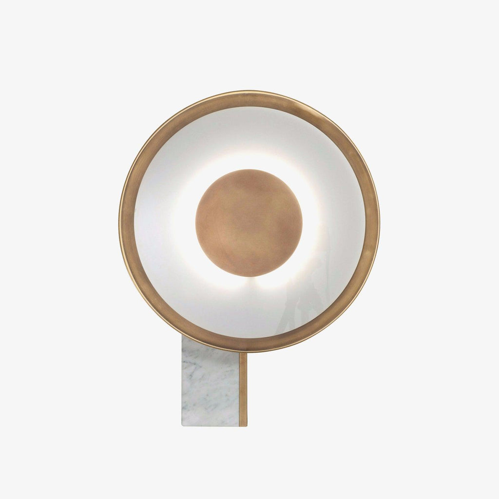 Close crop of the unlit Clérachic disc lamp on a plain off-white background, its marble foot visible at the base of the frame.