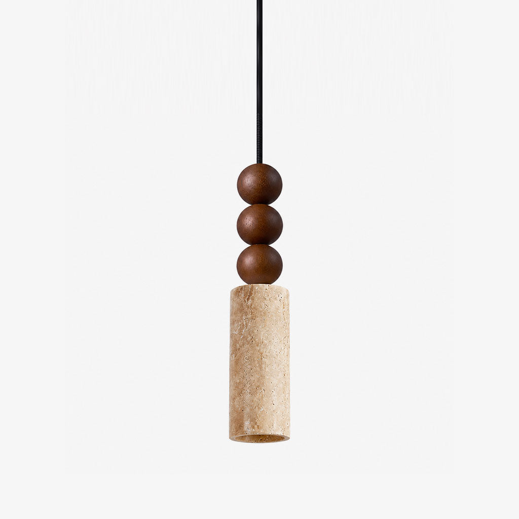 Close view of this Clérachic pendant's stacked wood beads above a travertine cylinder, shown against a plain grey backdrop.