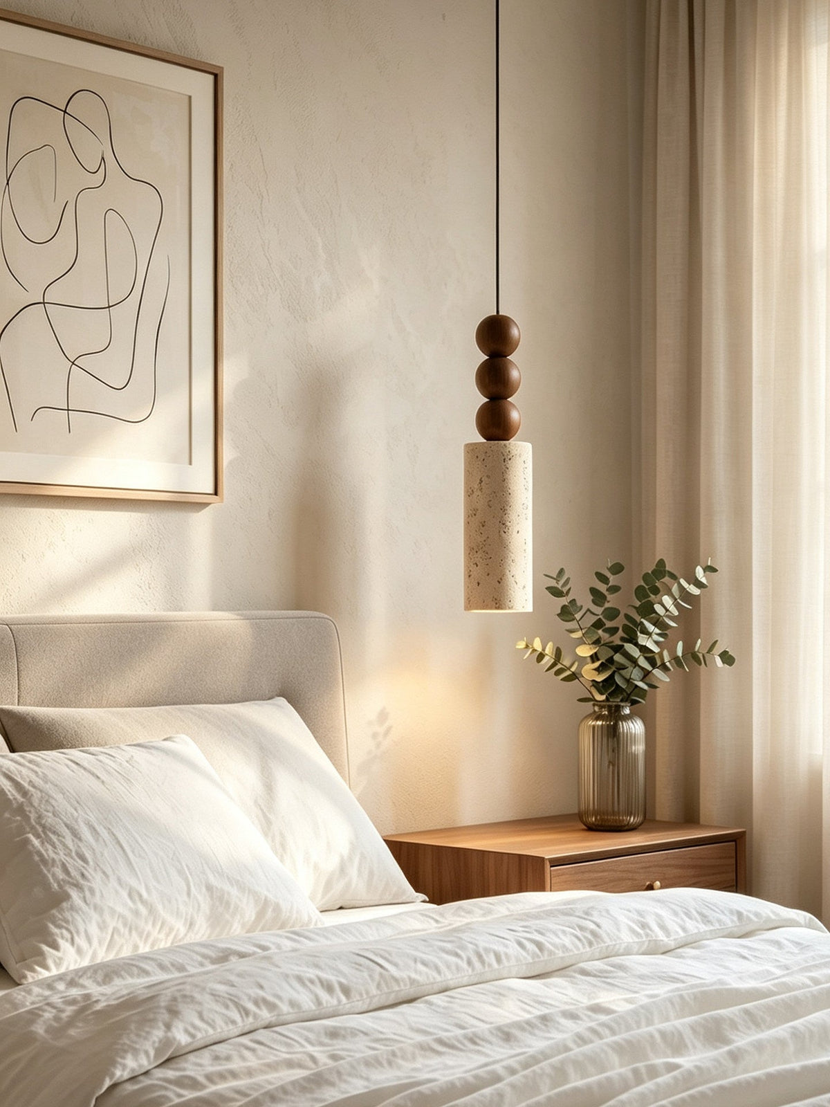 This Clérachic pendant glows beside sheer curtains, above a bed dressed beneath an abstract line-art print.