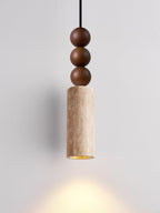 This Clérachic pendant's travertine cylinder casts a warm downward glow beneath its stacked wood beads.
