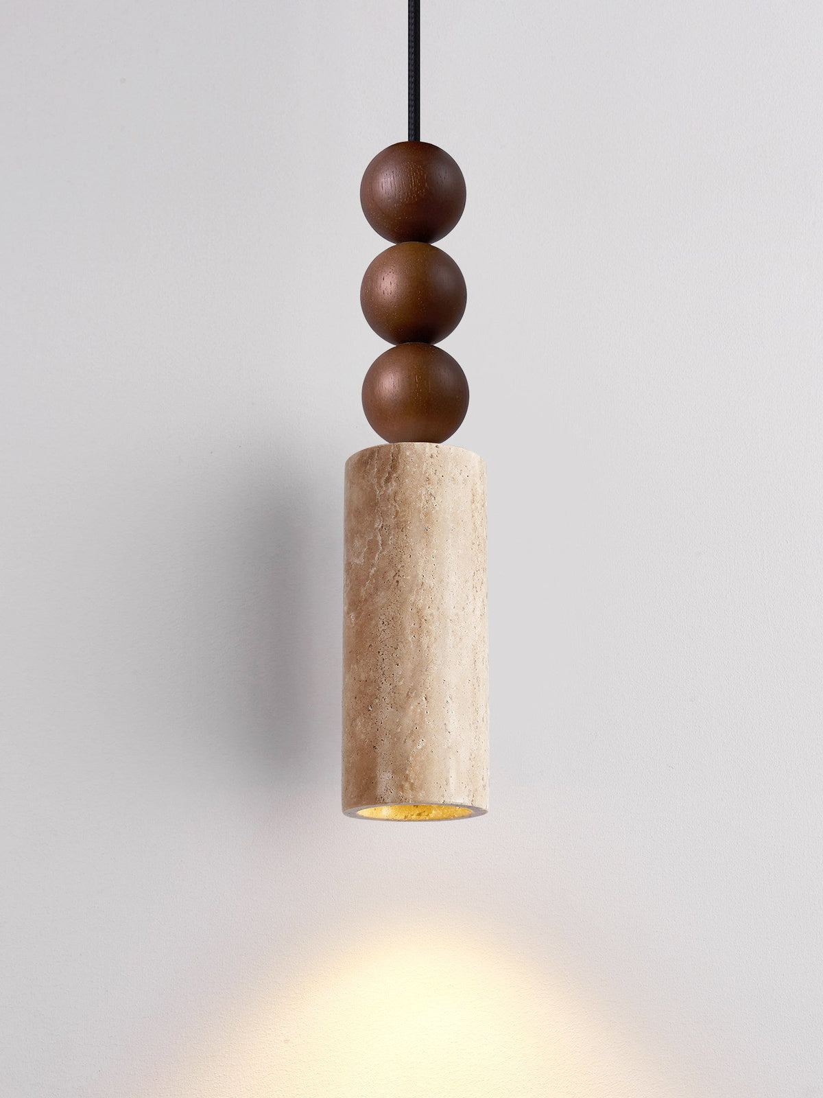 This Clérachic pendant's travertine cylinder casts a warm downward glow beneath its stacked wood beads.