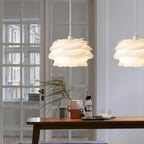 Floral pendant light with white rose petals lit warmly