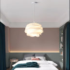 Rose floral pendant light shown lit in a bedroom