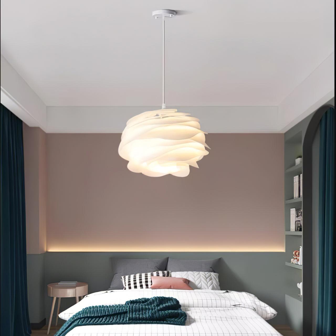 Rose floral pendant light shown lit in a bedroom