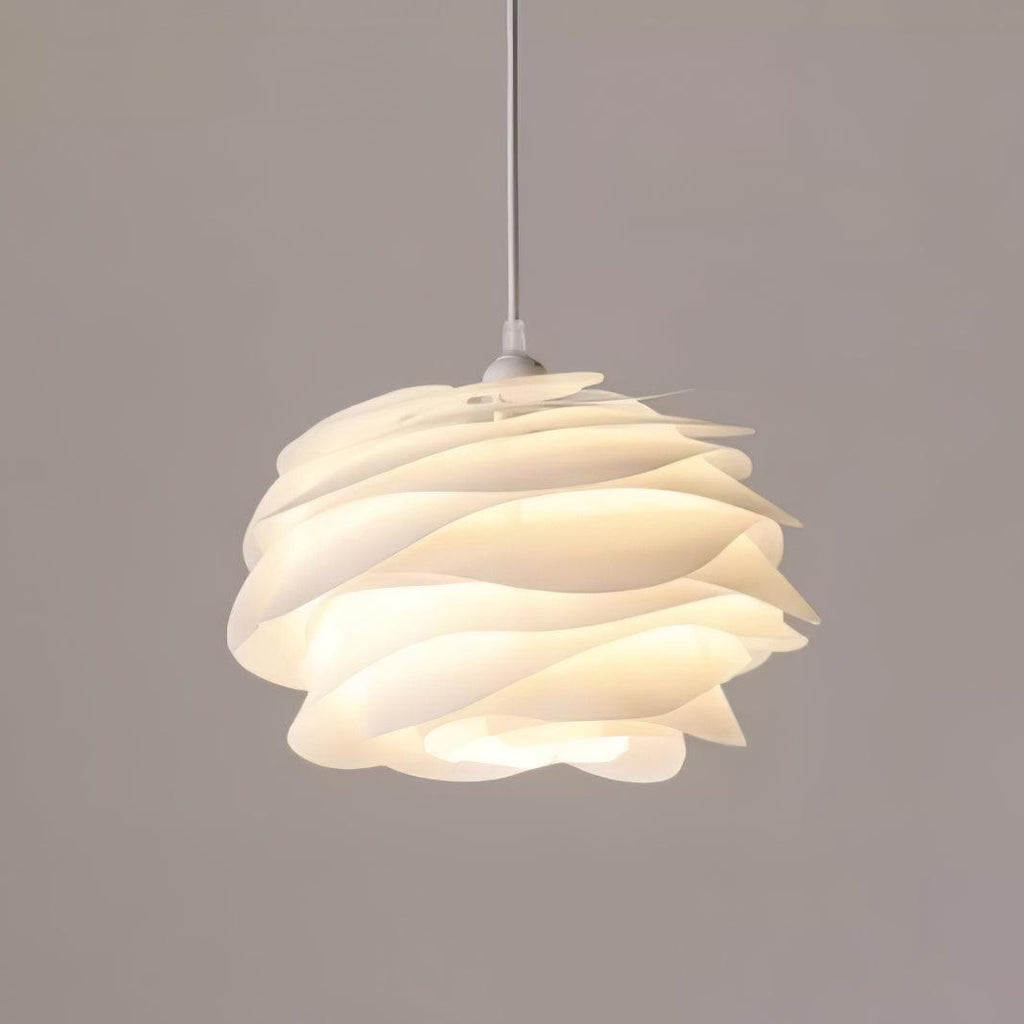 White floral rose pendant light glowing above a table