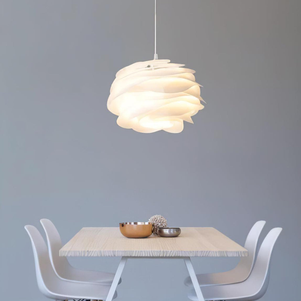 Floral pendant light in white glowing against a dark wall