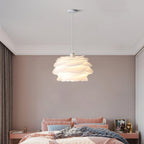 Floral pendant light with white roses over a side table