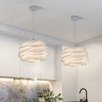 Floral pendant light with white roses lit in an entry hall