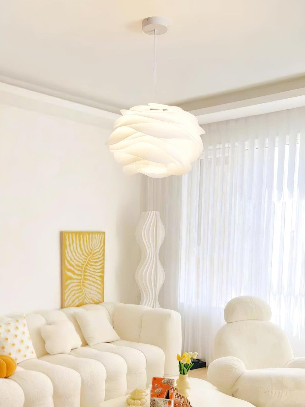 White rose pendant light glowing in a styled bedroom