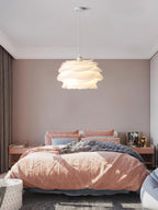 White rose pendant light suspended in an entryway