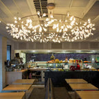 Firefly chandelier glowing softly above a dining space