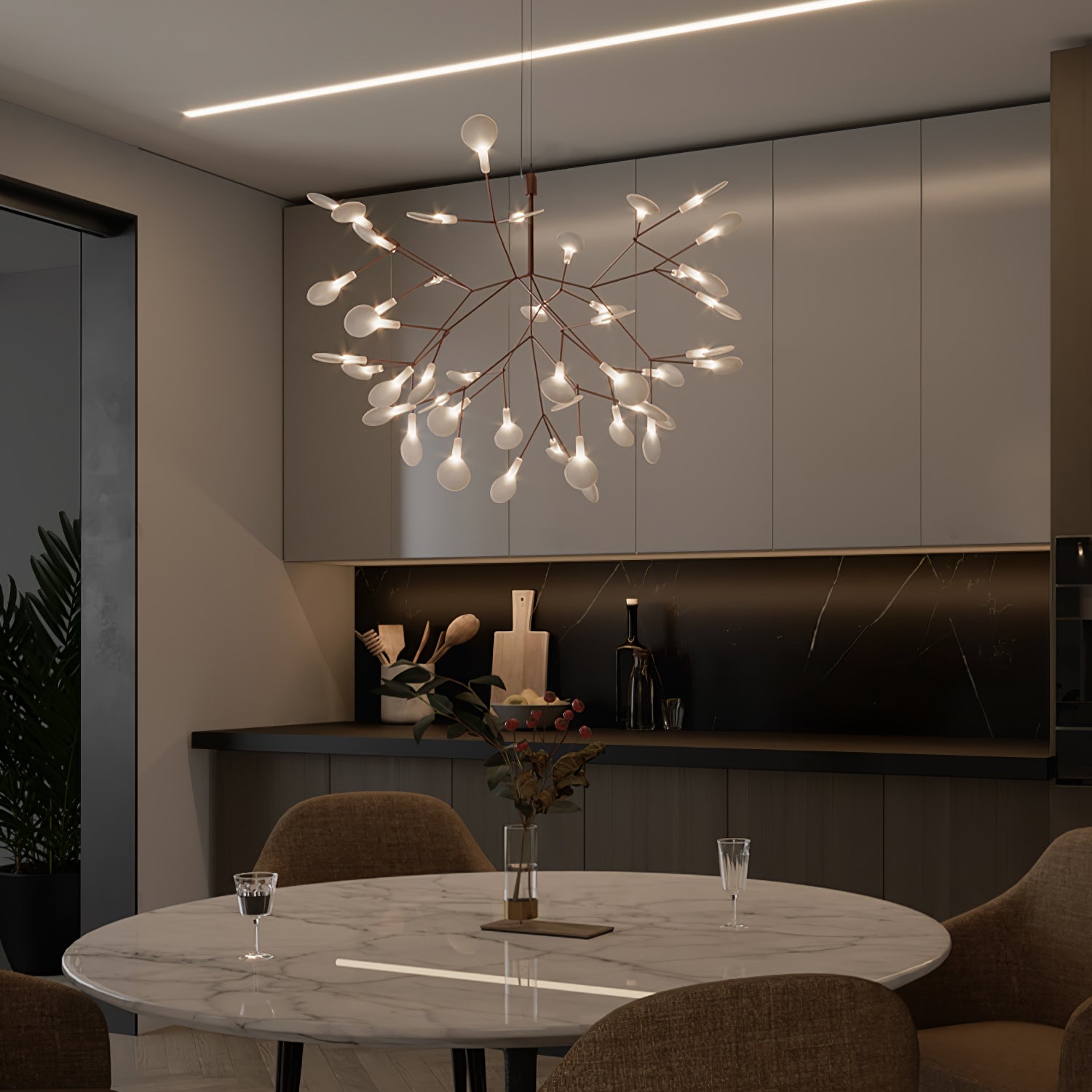 Rose gold branch chandelier with warm glowing leaves