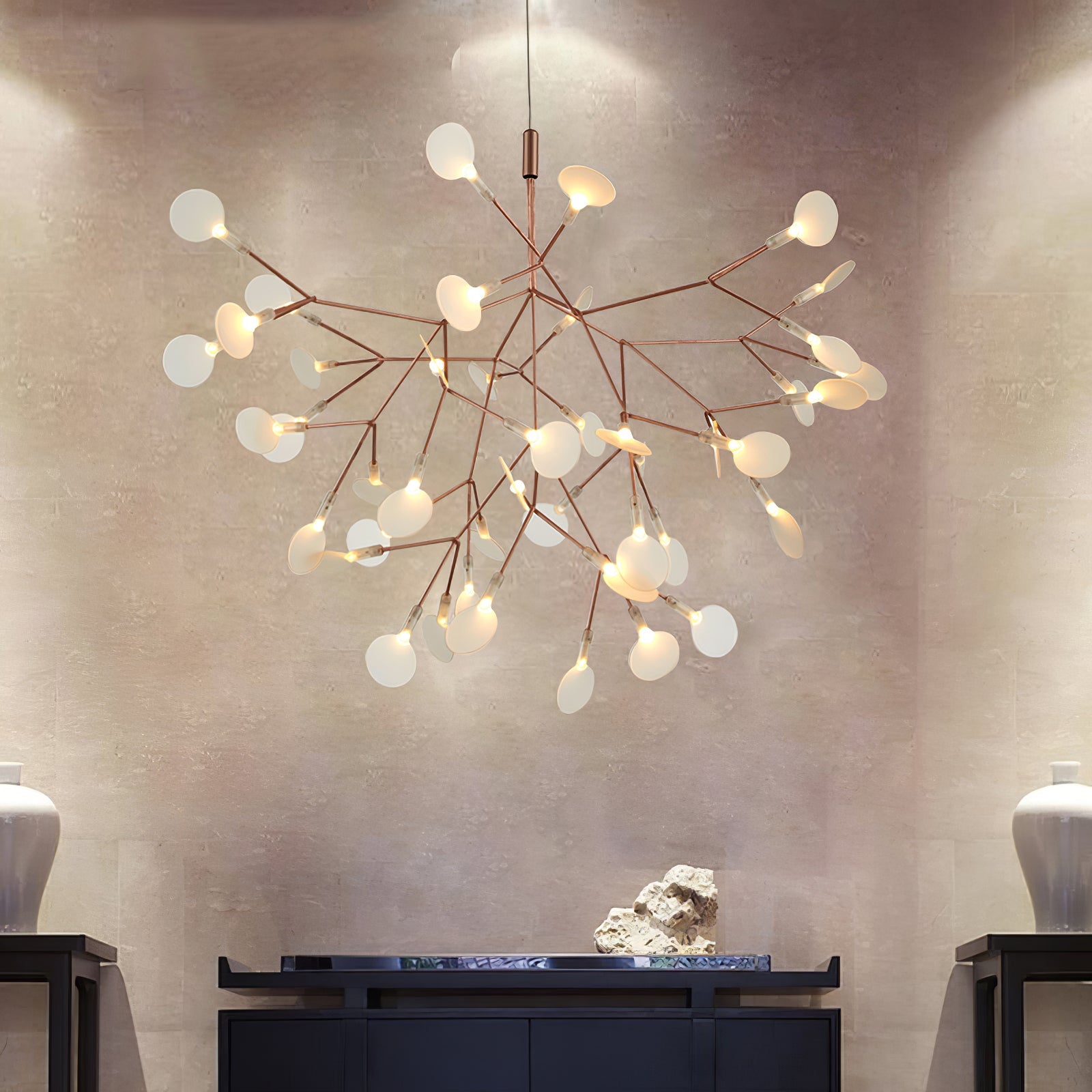 Rose gold chandelier with conductive leaf lights glowing
