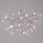 Rose gold firefly chandelier suspended over a table