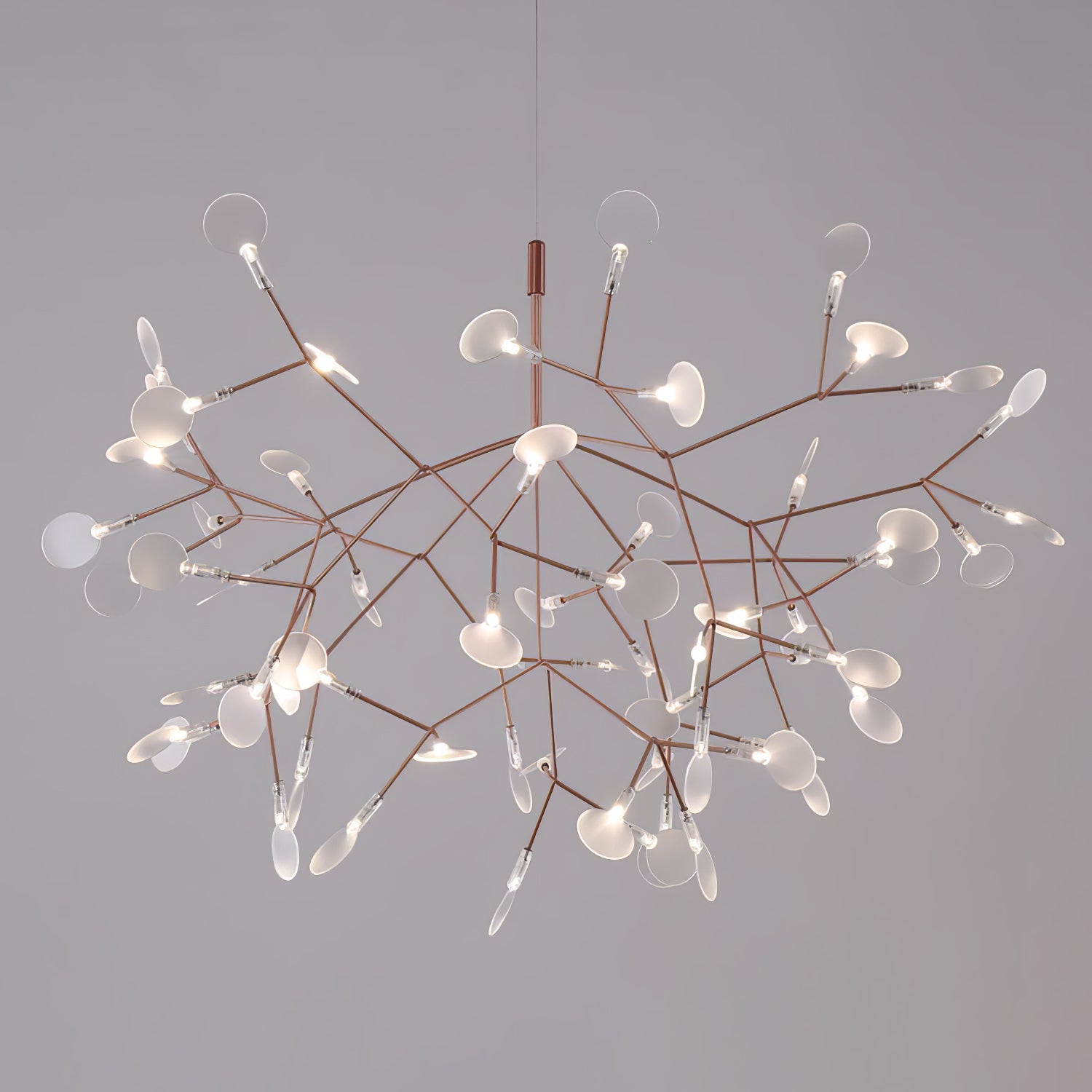 Rose gold firefly chandelier suspended over a table