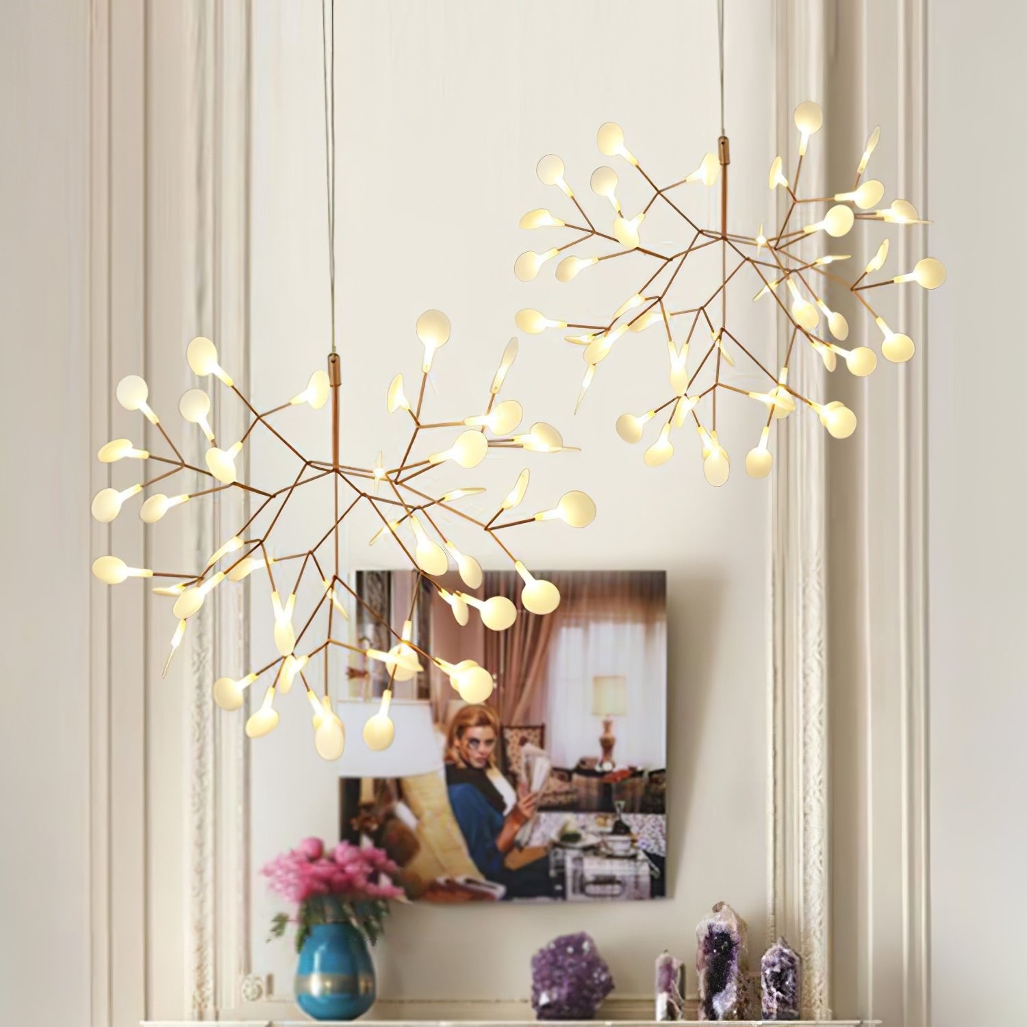 Rose gold firefly chandelier lit warmly over a table
