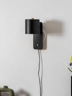 Cylinder wall lamp shown angled down for directed reading light