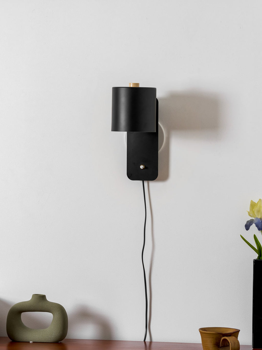 Rotatable cylinder wall lamp mounted on a textured wall surface